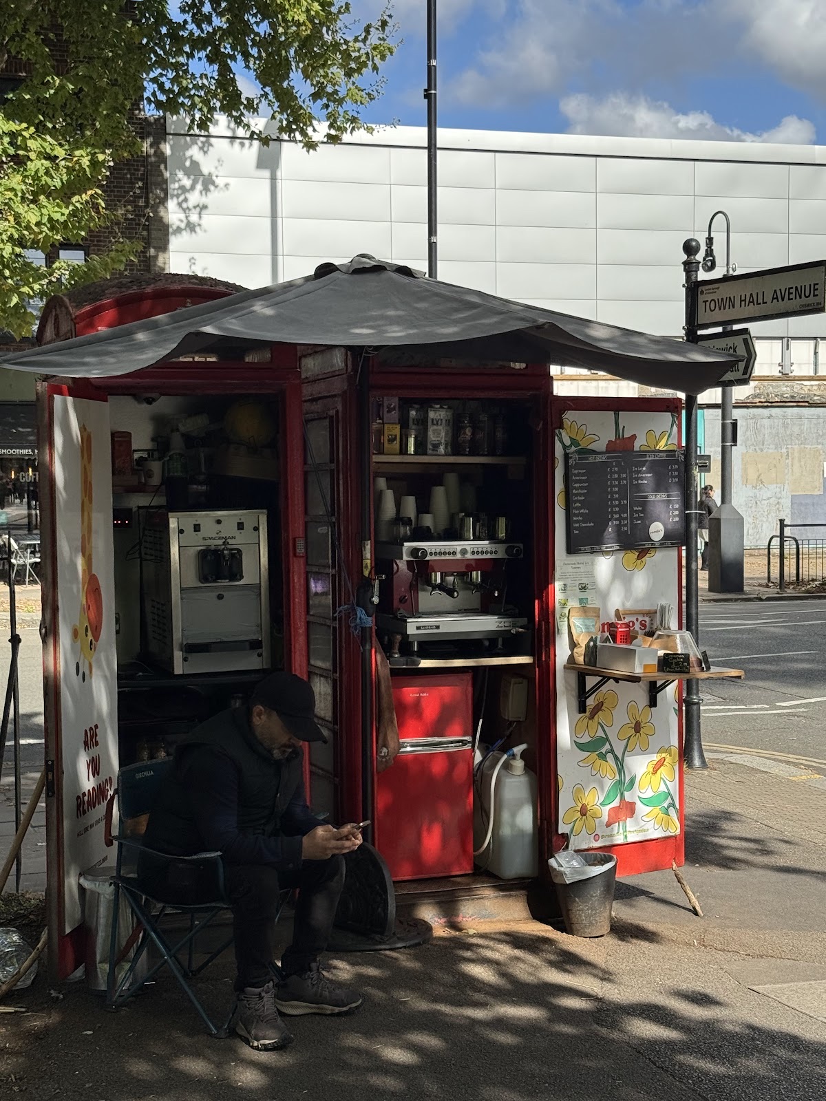 The open kiosk with its espresso machine and shelves of stock